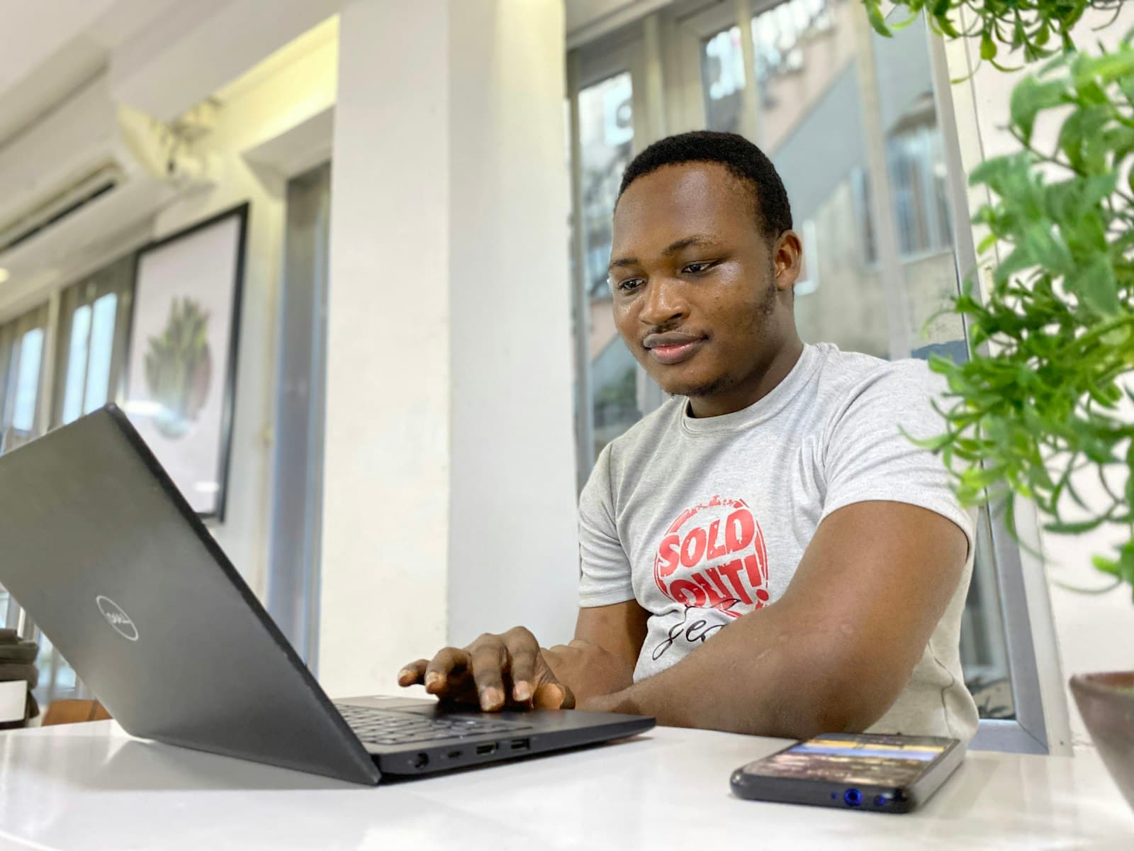 Young man working on a laptop at a desk